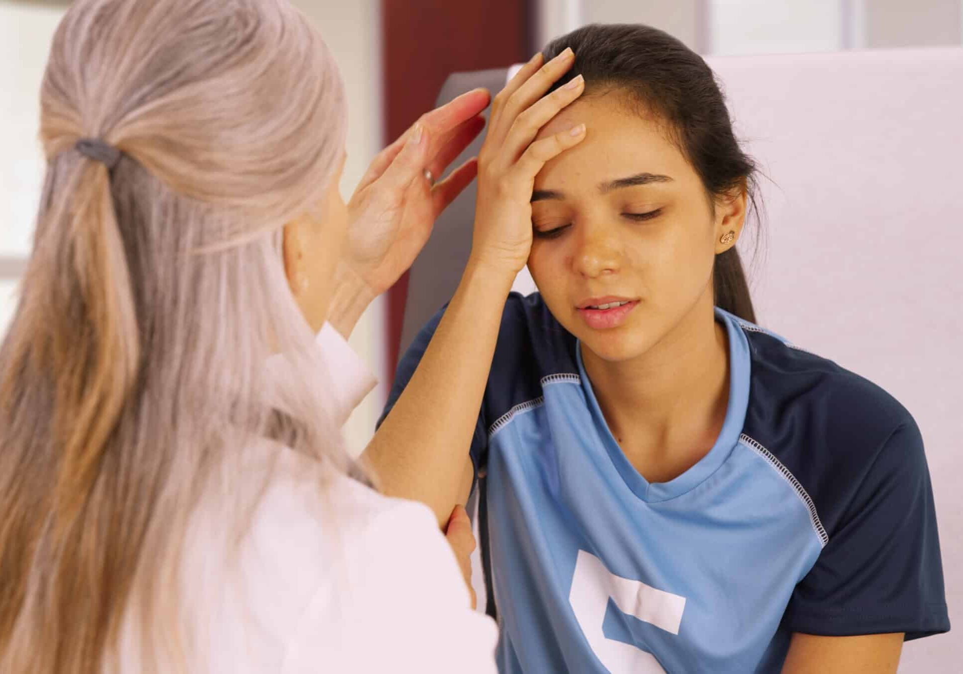 A young soccer player with a head injury recieves medical attention